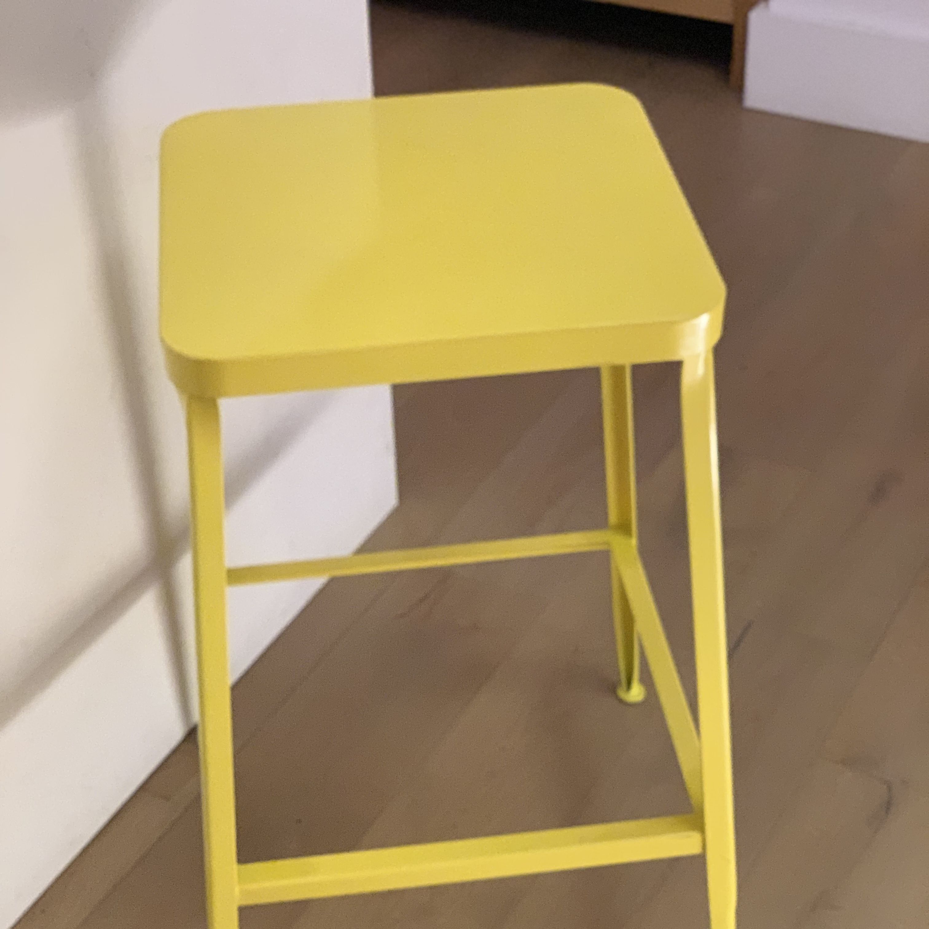 pair of cb2 flint yellow counter stools