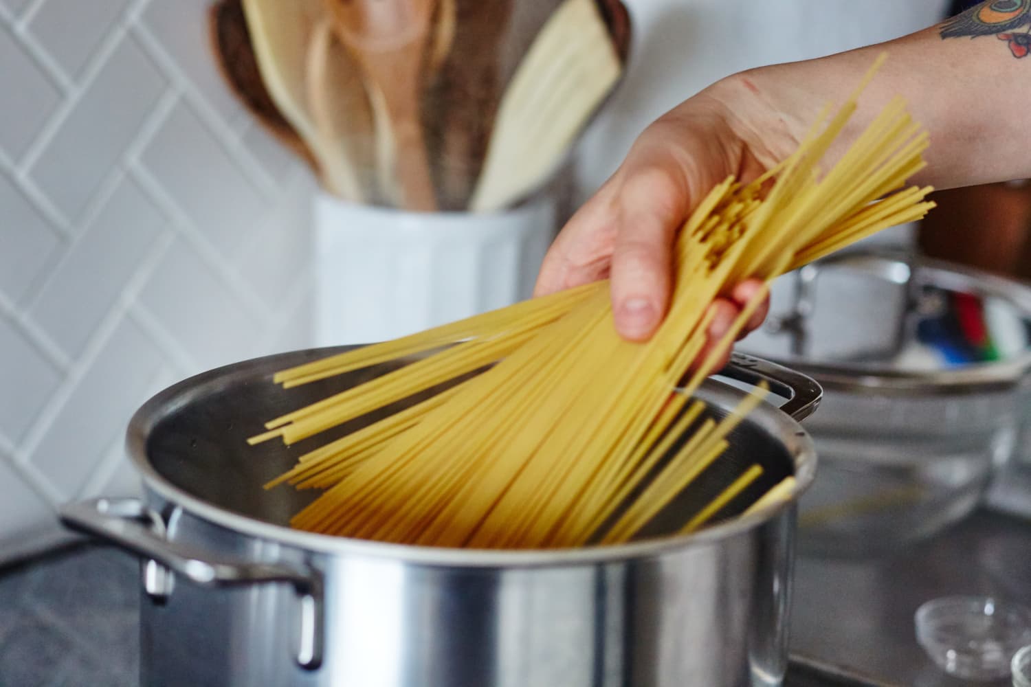 cooking-long-pasta-in-a-short-pot-is-breaking-noodles-bad-form-kitchn