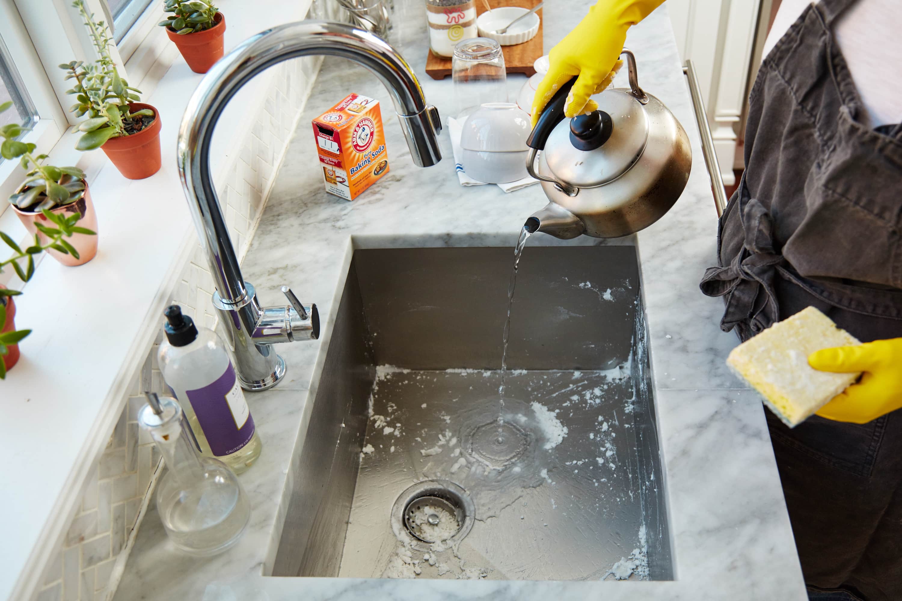 clean kitchen sink with lysol wipe