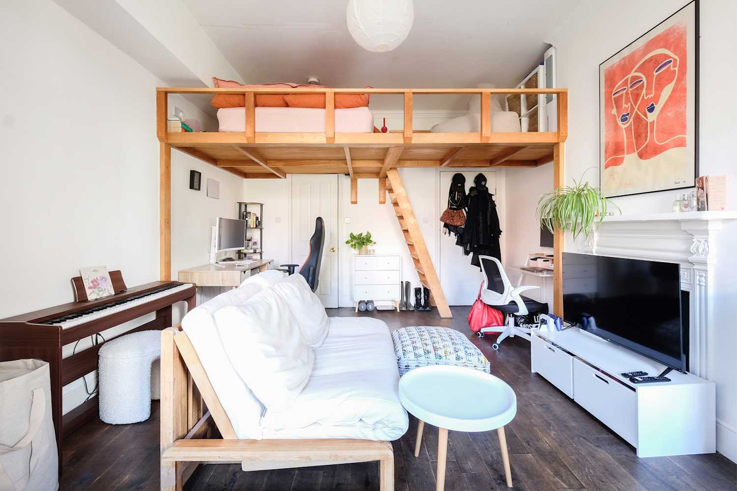 This Couple's 250-Square-Foot Studio Somehow Fits Two Desks, a Dining Area - Even a Piano