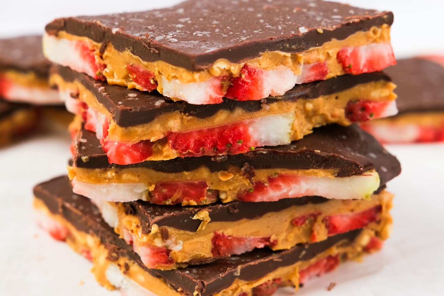 Peanut butter chocolate bark broken into pieces with toppings