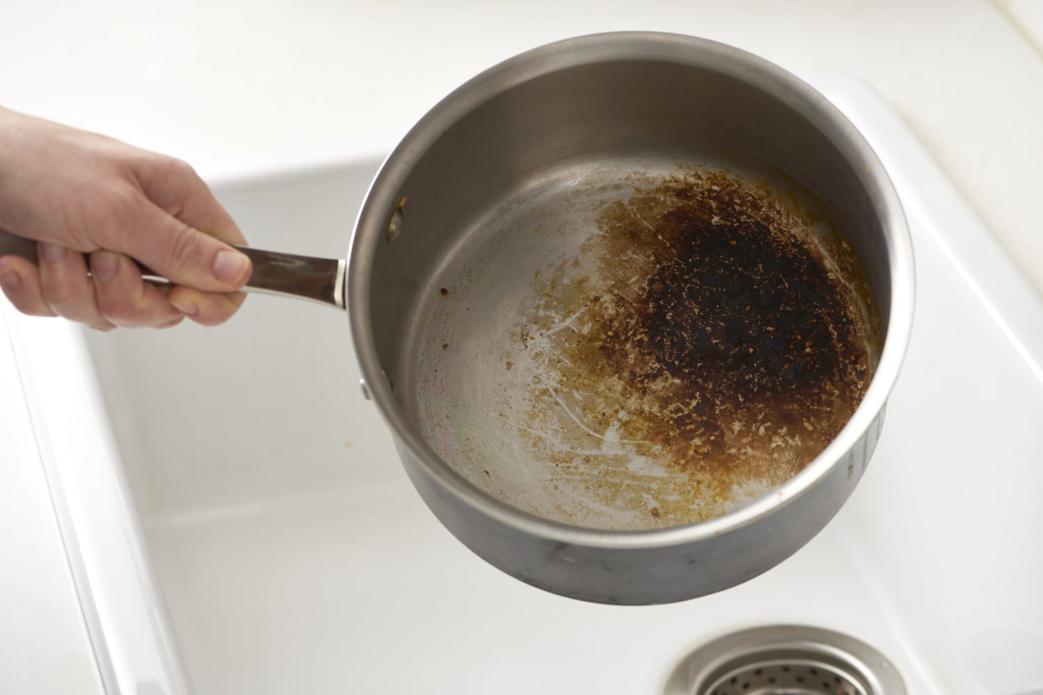 Tips for removing burnt pieces of a pot holder from bottom of