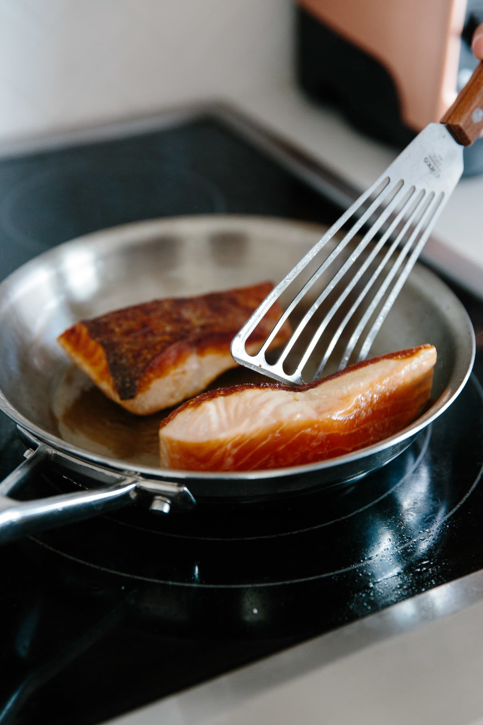 Grill pan with delicious salmon steaks on stove in kitchen Stock