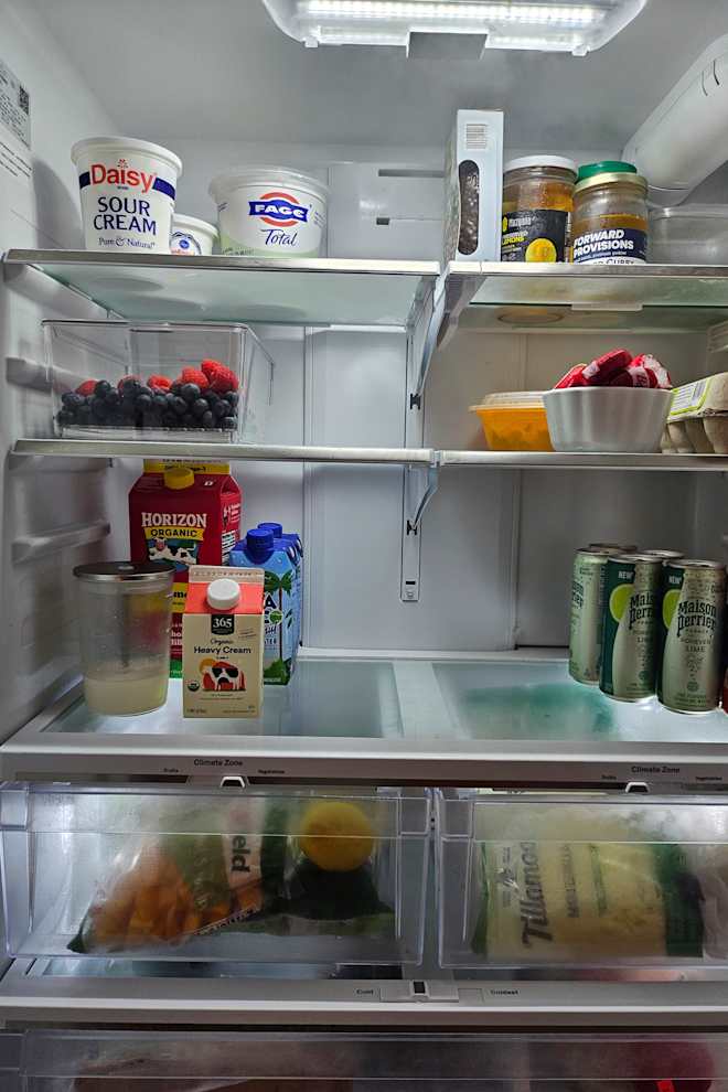 The Stackable $14 Kitchen Storage Gem a Pro Organizer Made Me Get That Makes My Fridge Feel 3x Bigger