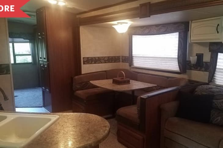 Before: Outdated kitchen and dining area in camper