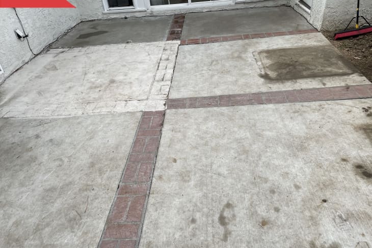 Before: Dirty and patchy concrete patio