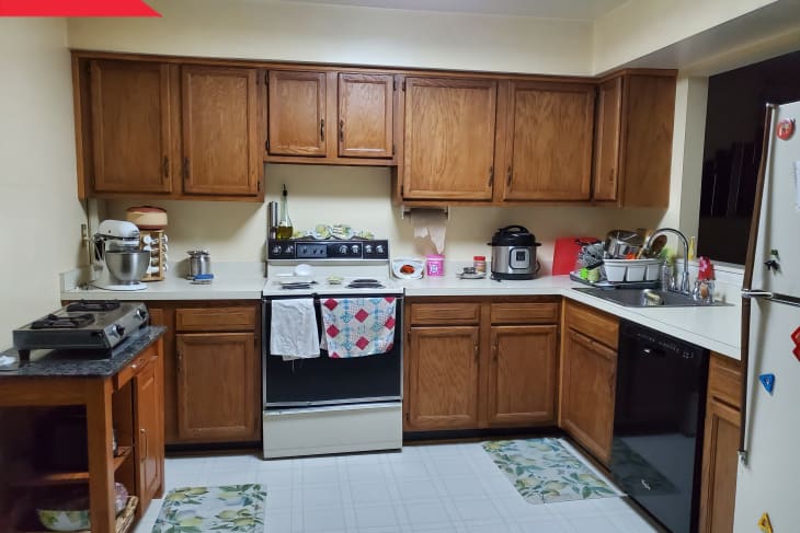 Before: Dated kitchen with dark brown cabinetry and old appliances