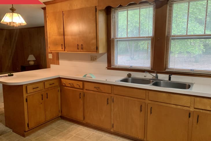 Before: 1970s-style kitchen with brown wood cabinets, beige vinyl floor, and off-white countertops