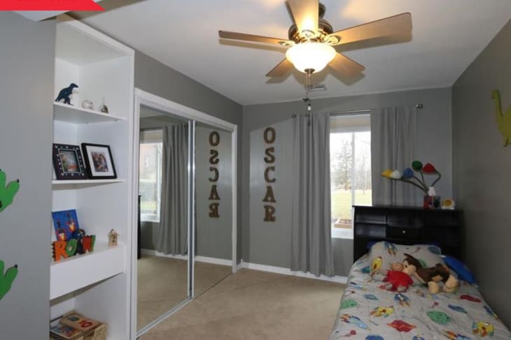 Before: bedroom with gray walls, twin bed, and mirrored closet doors