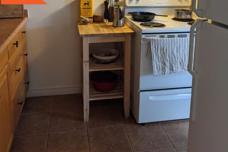 Before: kitchen with brown cabinets, brown tile floor, and white stove