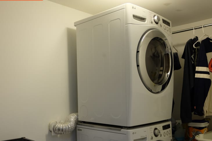 Before: Stacked washer/dryer in corner of laundry room
