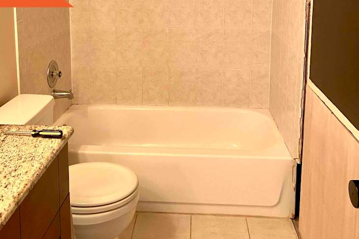 Before: white tub next to white toilet