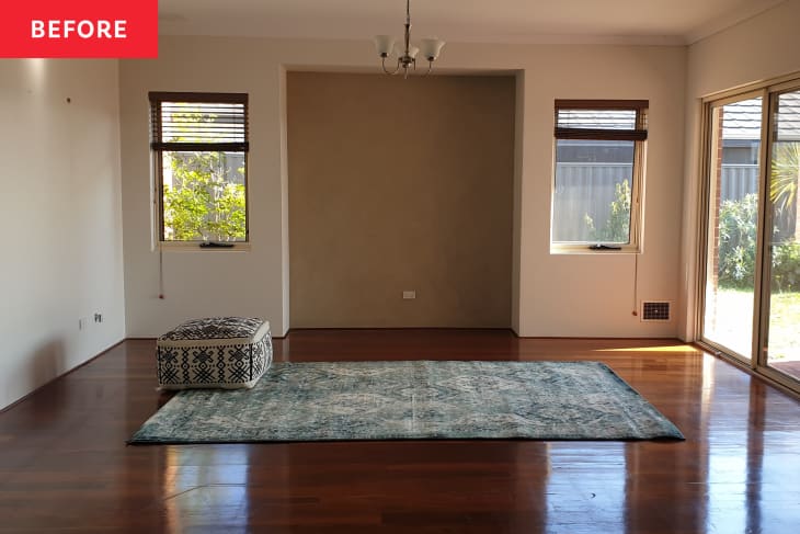 Before: and empty room with a blue rug