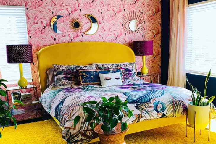 Bedroom with flamingo wallpaper and yellow bed