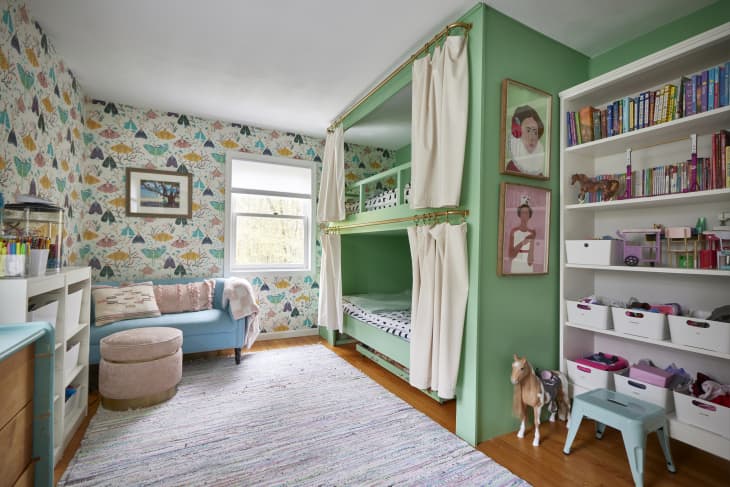Colorful kids bedroom with custom bunk beds. Butterfly wallpaper lines the room.