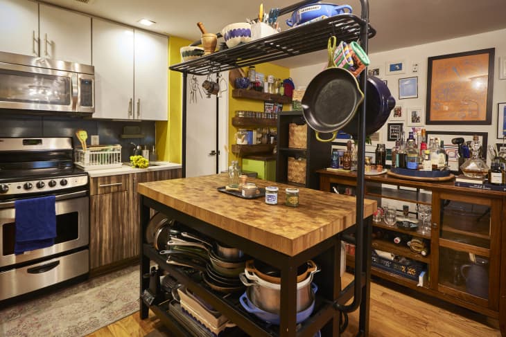 Cookware on kitchen island in small NYC kitchen.