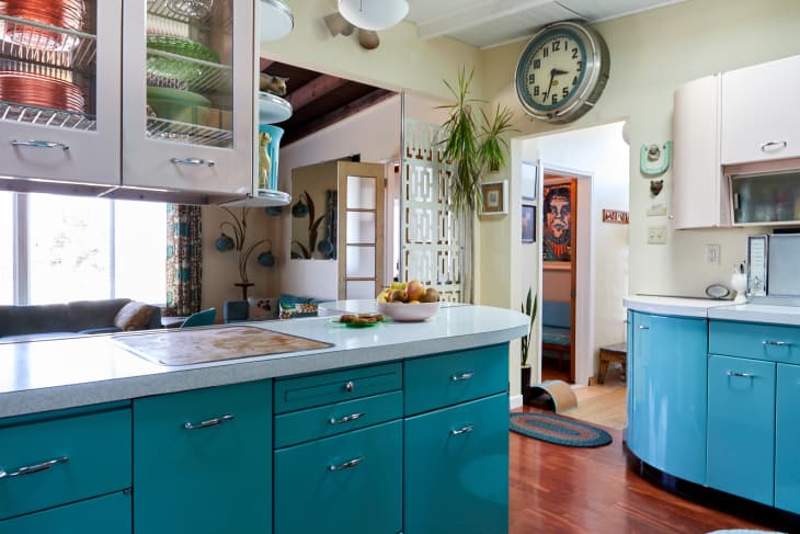 Vintage kitchen with blue bottom cabinets and pink top cabinets.