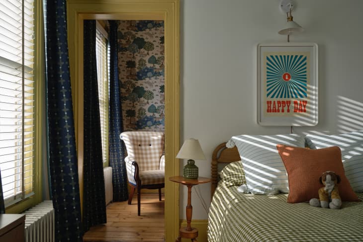 Yellow painted trim in bedroom with green plaid bedding.