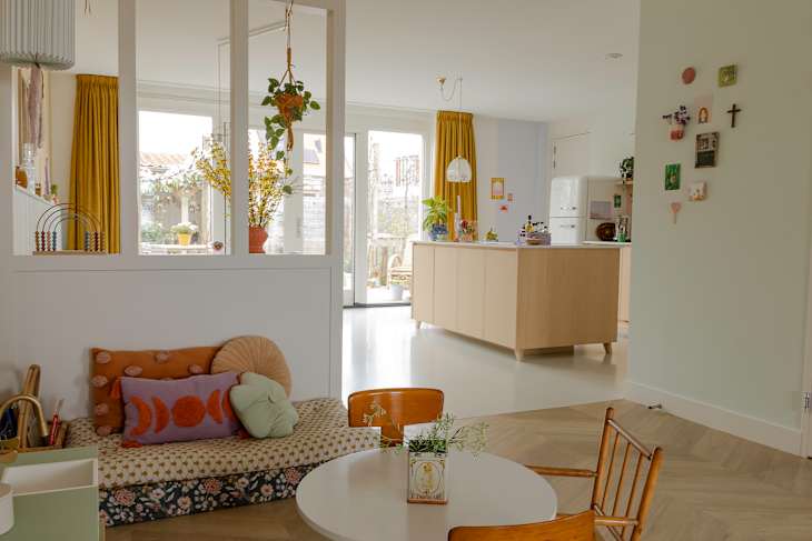 Wood kitchen island seen from children's play nook.