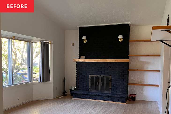 Black painted brick fireplace in living room before renovation.