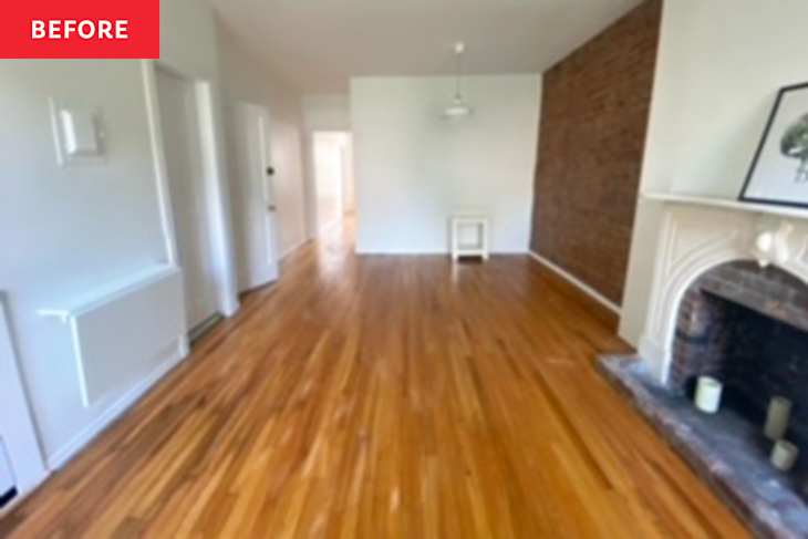 Living room with hardwood floors, white walls, a brick accent wall, and a decorative fireplace.