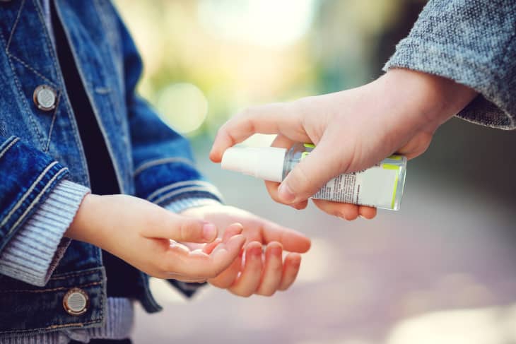 Kids hands using sanitizer gel, closeup. Children disinfecting hands with antiseptic gel. Coronavirus epidemic. Coronavirus quarantine. Sanitizer for prevent spread of germs, bacteria, coronavirus