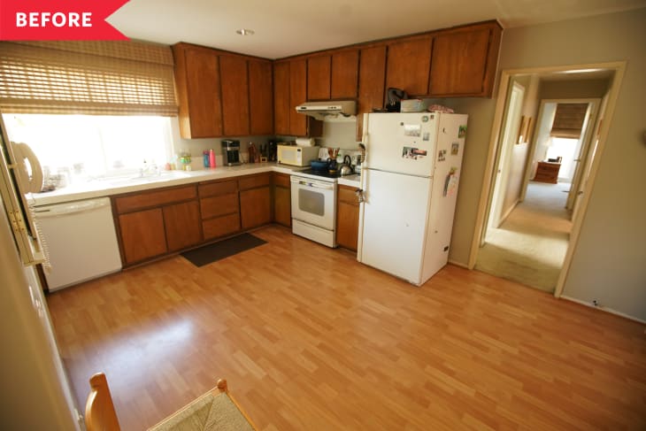 Before: Kitchen with brown cabinets in L-shape along one corner, white appliances, and light brown wood floors