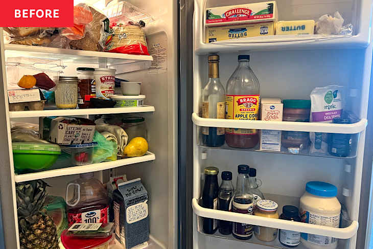 A cluttered refrigerator filled with various food items, condiments, and drinks, including fruits, jars, and containers.