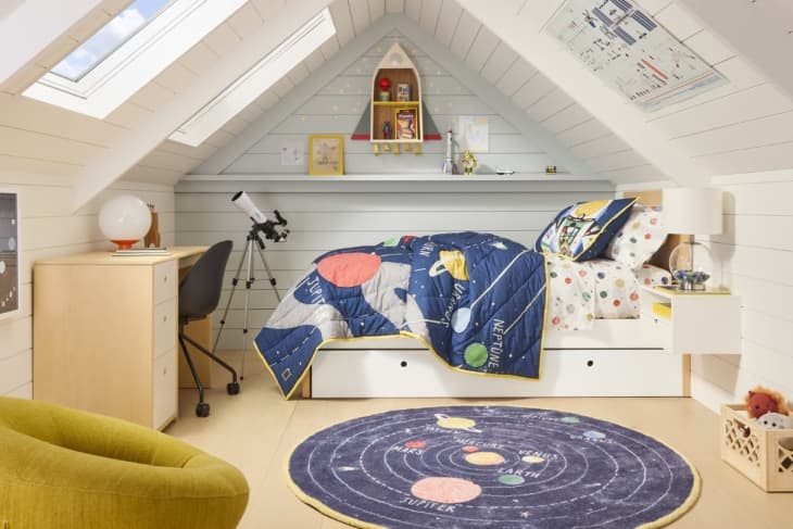 solar system rug, solar system comforter, telescope, rocket ship shelf, storage bed, wood desk, angled ceiling, skylight, paneled walls, solar system art