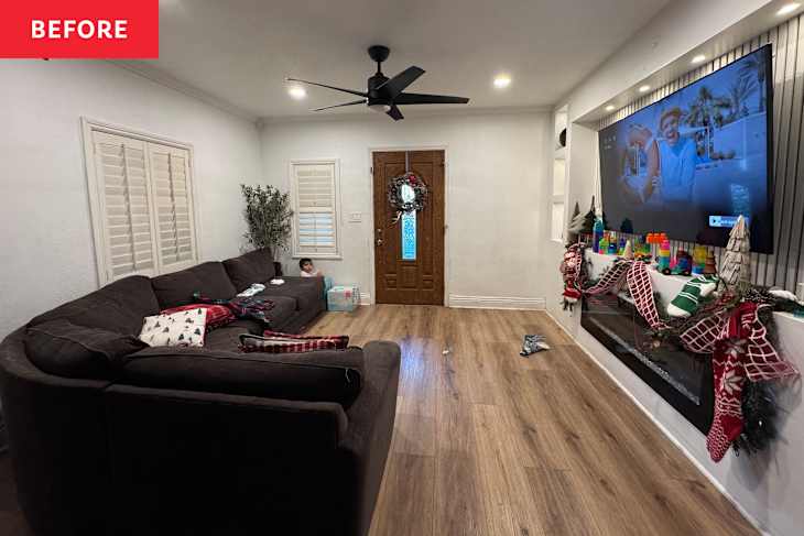White living room with white sofas and TV on wall with shelves and fluted accents after makeover