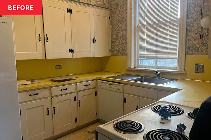 A small kitchen with white cabinets, yellow countertops, a double sink, and a stove with blue decorations.