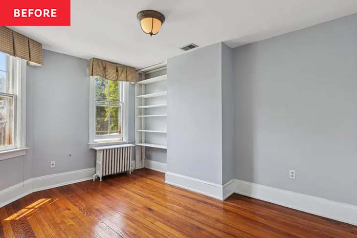 Empty room with gray walls, hardwood floor, two windows with checkered valances, and a built-in shelf.