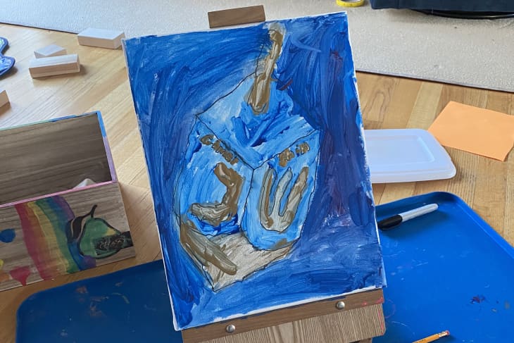 blue and gold kids' painting/art with big blue mat underneath