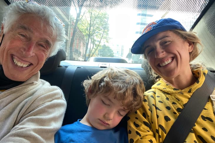 parent, grandparent, and child in car. Child is sleeping
