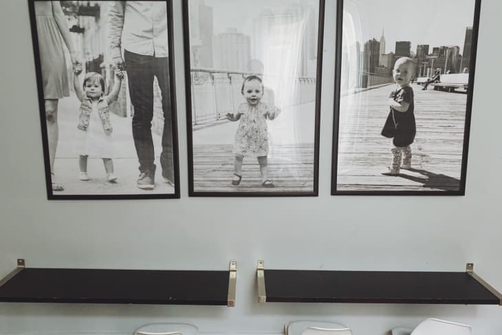 three black and white family portraits in a bedroom