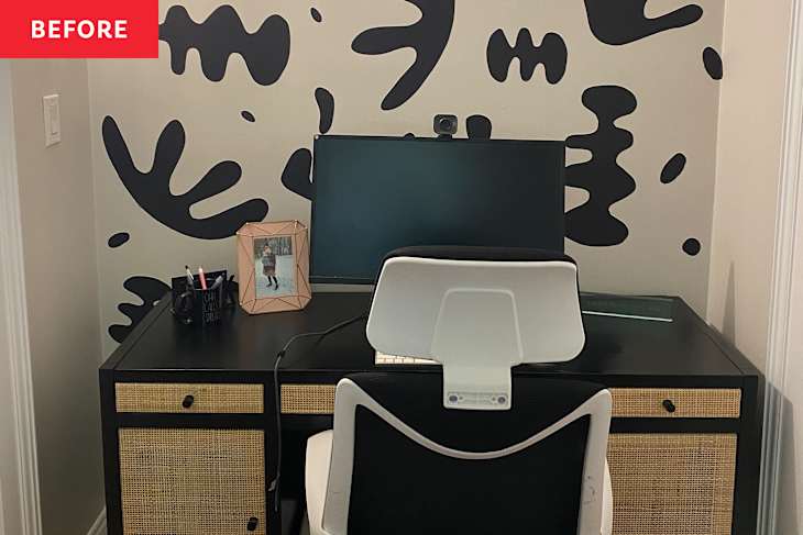 A modern home office setup featuring a black desk with rattan drawers, a computer monitor, and a white ergonomic chair.