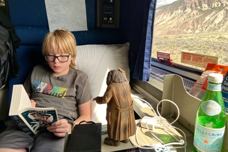 Boy reading book on train