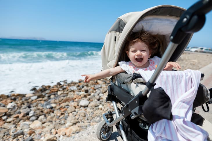 baby in stroller on beach