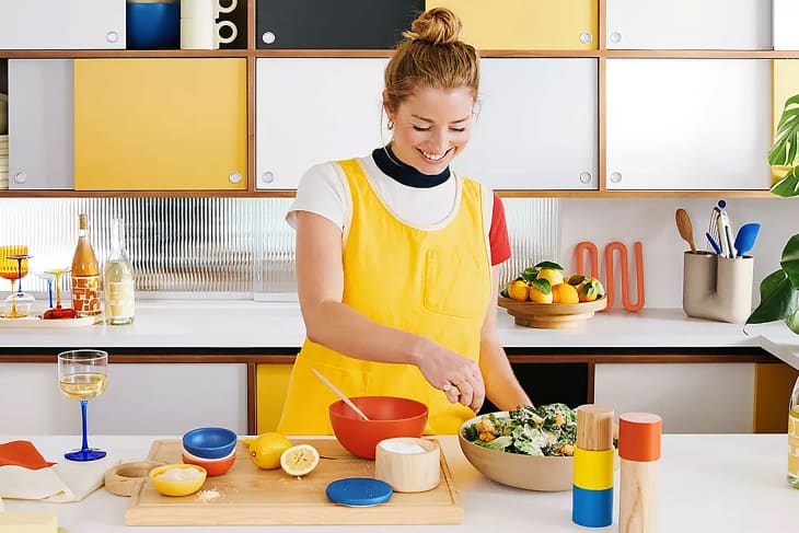 Molly Baz in kitchen with products from Crate and Barrel collaboration.