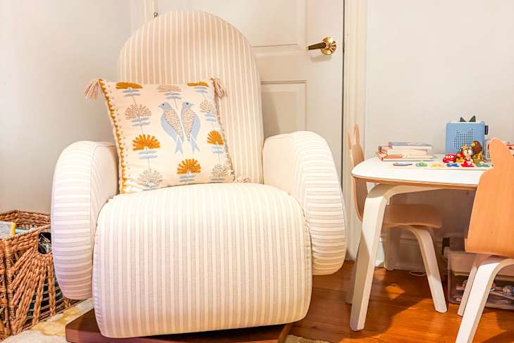 Throw pillow on top of Nestig swivel glider.