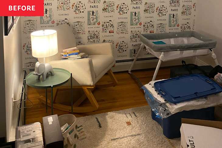 A cozy corner with a rocking chair, green side table, elephant lamp, and a bassinet, surrounded by boxes and books.