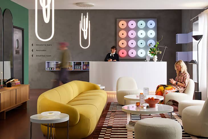 Full range of new colors of the IKEA VARMBLIXT LED table/wall lamp behind lobby desk