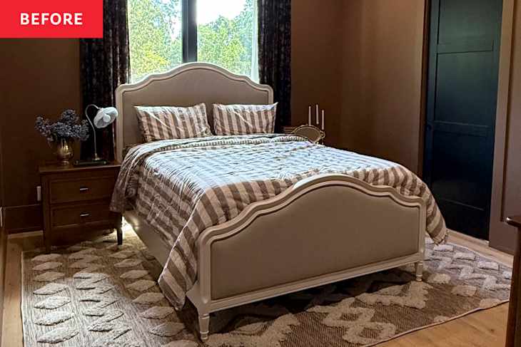 A cozy bedroom featuring a beige upholstered bed with striped bedding, a wooden nightstand, and a decorative rug.