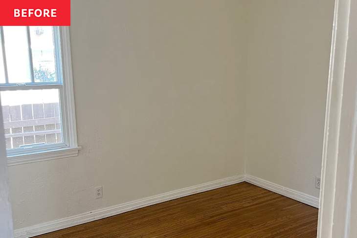 Empty room with light-colored walls, hardwood flooring, and a window with white trim.