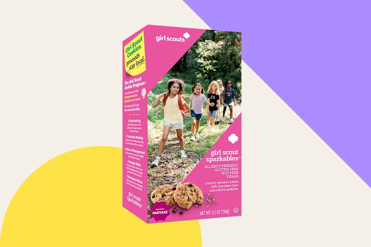 Box of Girl Scout Sparkables cookies featuring a colorful design, with children walking in a wooded area.