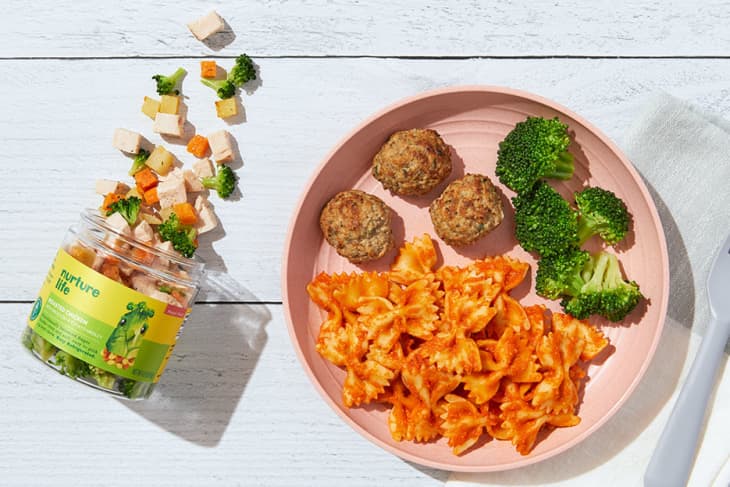 Pasta broccoli and meatballs for toddlers on a pink plate