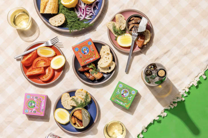 multicolored cake plate spread with tinned fish