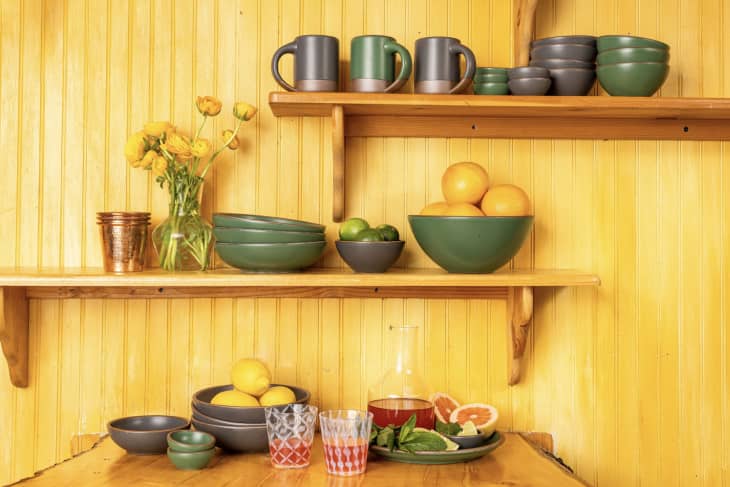 black and green ceramic dishes against yellow background