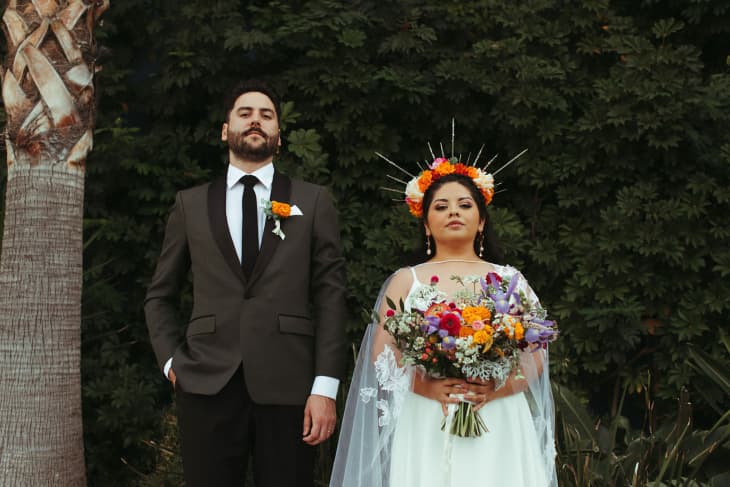 Couple standing outside at their wedding.