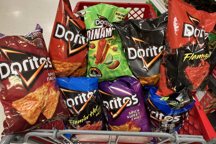 Multiple bags of Doritos in a grocery shopping cart